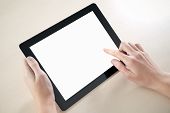 stock photo of holding  - Woman hands holding and point on electronic tablet pc with blank screen - JPG 