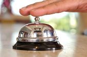 stock photo of rush  - Hand of a man using a hotel bell  - JPG 