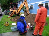 stock photo of construction worker  - Three workers making repairs in a residential neighborhood - JPG 