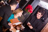 pic of restaurant  - Waiter taking an order from a couple at the restaurant - JPG 