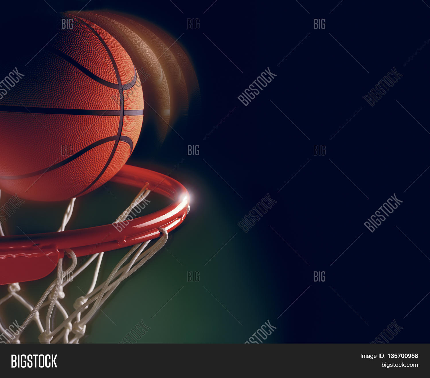 basketball going in hoop score ball green background Stock Photo