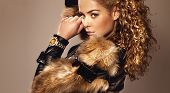 picture of watch  - Portrait of beautiful young girl wearing fashionable fur and watch looking at camera - JPG 