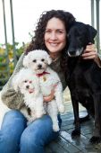 image of dog  - A portrait of a happy mature woman with her dogs outdoor - JPG 