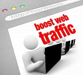stock photo of internet  - A web browser window shows the words Boost Web Traffic and several people working on laptop computers - JPG 