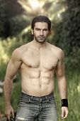stock photo of males  - Portrait of a hunky male fitness model shirtless in beautiful outdoor natural setting - JPG 