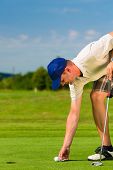 pic of golf  - Young golf player on course putting - JPG 