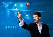 stock photo of future technology  - Businessman pressing social media button on digital map - JPG 