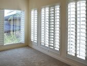 stock photo of interior  - White plantation style wood Shutters for luxury Interior Design in condo - JPG 