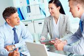 stock photo of meeting  - Image of three confident business partners interacting at meeting - JPG 