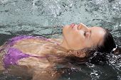 foto of health  - Beautiful young female floating on her back in a Jacuzzi at health spa - JPG 