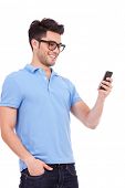 picture of man  - Young casual man reading something on his phone and smiling - JPG 
