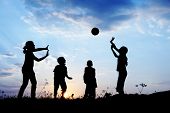 foto of sunset  - Happy children playing hand ball at sunset time - JPG 