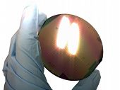 picture of silicon  - Silicon wafer in a hand under bright light - JPG 