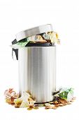 stock photo of money  - Waste of money concept with waste money in and around a trash can on white - JPG 