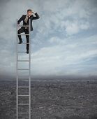 stock photo of future  - Businessman looking the future on a stairs - JPG 