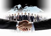 pic of handshake  - business handshake against white background and standing businesspeople - JPG 