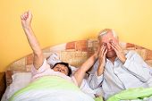foto of wake  - Senior couple in bed stretching and waking up - JPG 
