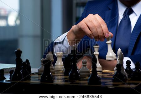 Poster: Businessman playing chess in strategy