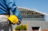 stock photo of construction  - A construction worker or foreman at a construction site observing the progress of construction job or project with copy space - JPG 