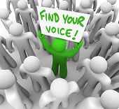 picture of opinion  - The words Find Your Voice on a banner held by a green man in a crowd of grey people - JPG 