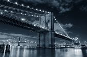 image of bridge  - Brooklyn Bridge over East River at night in black and white in New York City Manhattan with lights and reflections - JPG 