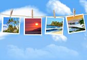 foto of  photo  - Travel photos hanging on a clothes line against a blue sky - JPG 