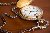 foto of watch  - Old retro pocket watch with chain on table - JPG 