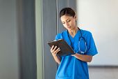 stock photo of medical  - young female medical nurse using tablet computer in hospital office - JPG 