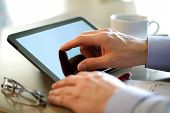 foto of businessmen  - Businessman finger pointing to the screen of a tablet - JPG 