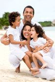 pic of family  - happy family smling at the beach while on vacation - JPG 