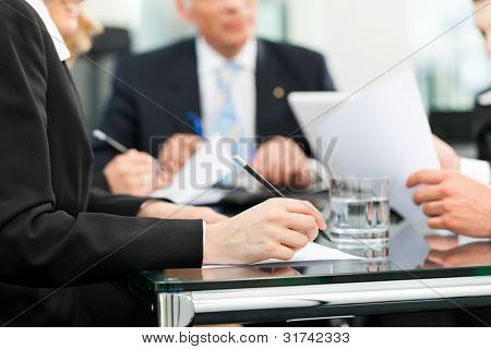 Picture or Photo of Business - meeting in an office, lawyers or attorneys discussing a document or contract agreement
