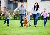 picture of family  - Happy family running with their dog outdoors - JPG 