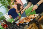stock photo of tilting  - Chicken quarters and sausages on the grill - JPG 