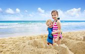 image of beach  - Children building Sandcastles on the Beach - JPG 