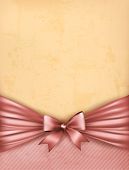 image of holidays  - Vintage background with red gift bow and ribbon on old paper - JPG 
