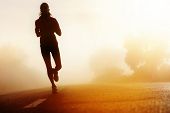 stock photo of fitness  - Runner athlete feet running on road - JPG 