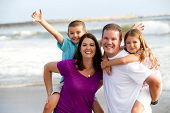 foto of family  - Happy loving family playing on the beach - JPG 