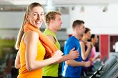 foto of fitness  - Running on treadmill in gym or fitness club  - JPG 