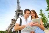 image of france  - Tourists using electronic tablet in front of the Eiffel tower - JPG 