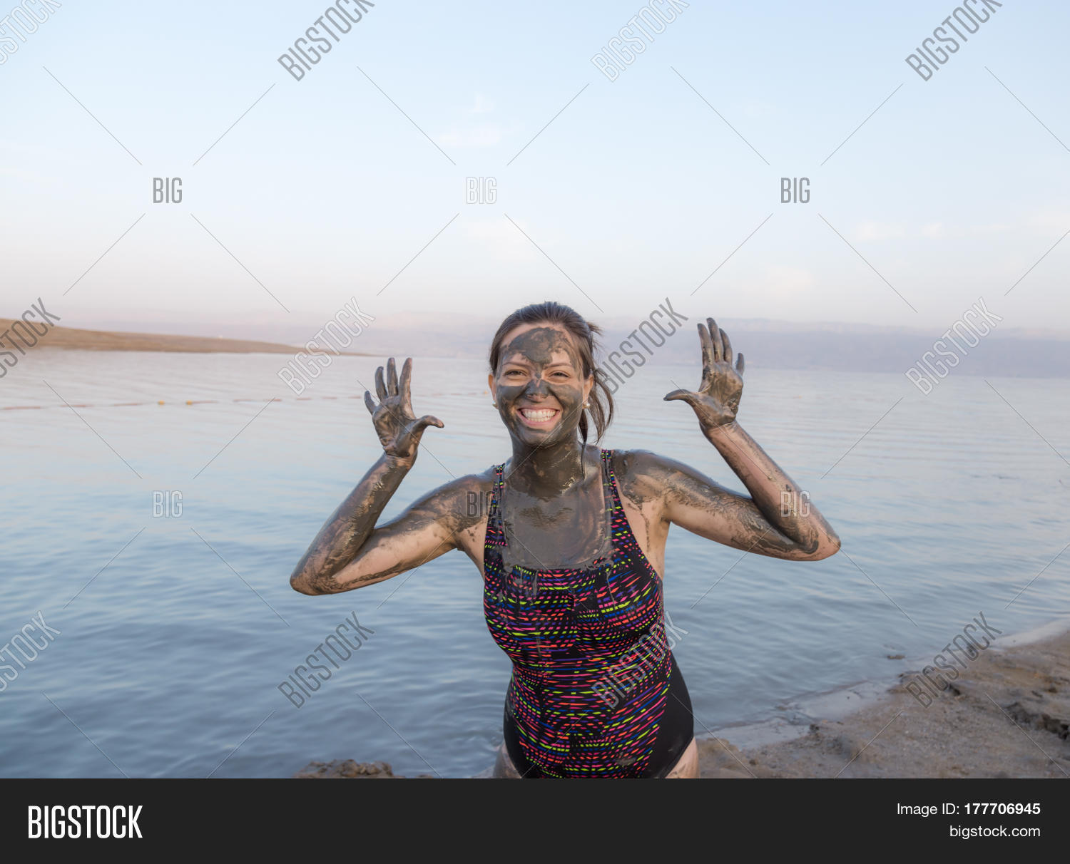 Portrait Of Beautiful Girl Applying Dead Sea Mud Body Care Treatment In