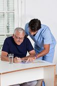 stock photo of puzzle  - Portrait of mature man playing sudoku puzzle - JPG 