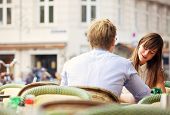 pic of casual  - Casual woman having a conversation with her date in an open air restaurant - JPG 