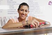 stock photo of ice  - Portrait of teenage girl working in ice cream shop - JPG 