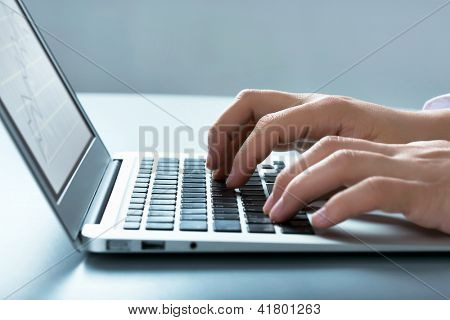 Picture or Photo of Closeup of businessman typing on laptop computer