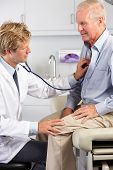 picture of md  - Doctor Listening To Male Patient - JPG 