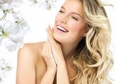 stock photo of blond  - portrait of attractive  caucasian smiling woman blond isolated on white studio shot  toothy smile face long hair blond head and shoulders hands nails flowers - JPG 