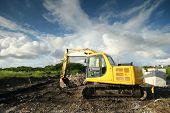 pic of construction  - a yellow mechanical digger on a construction site - JPG 