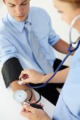 stock photo of pressure  - Doctor taking young man - JPG 