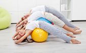 pic of home  - Happy healthy people exercising at home on large gymnastic balls - JPG 