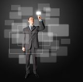 image of business people  - full length asian businessman push the button on virtual touch pad - JPG 